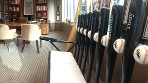  A White Sox-themed bench made of baseball bats featuring family members' names sits in Andrew Berlin's West Loop office. 